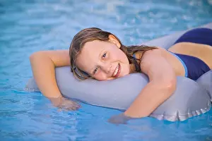 Chilled Prints: SPAIN IBIZA 10 YEAR OLD GIRL CHILD FEMALE LYING ON LILO INFLATABLE AIR MATTRESS IN SWIMMING POOL SMILING HAPPY FUN PLAY