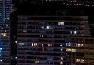 Penthouse Prints: The Spanish town of Benidorm in Spain showing apartment building windows in the evening time showing lights