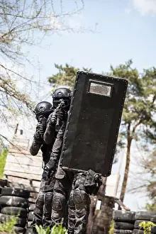Vest Prints: Spec ops police officers SWAT in black uniform in action