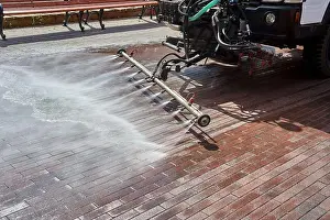 Cleanup Prints: A special machine washes city paths and roads with water