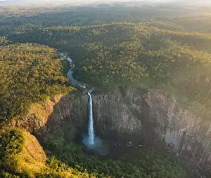 Spectacular aerial view of powerful Wallaman Falls flowing through rocky cliff in Girringun National Park covered with
