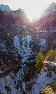 Ledge Prints: Spectacular drop down view of waterfall falling over rocky forest ledge