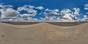 Cumulus Clouds Prints: spherical 360 hdri panorama on gravel road with clouds and sun on blue sky in equirectangular seamless projection