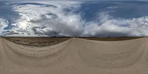 Spherical Panorama Prints: spherical 360 hdri panorama on gravel road with overcast sky before storm in equirectangular seamless projection
