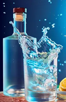 Droplets Prints: Spirits bottle and tumbler glass with alcohol splashing out of the glass