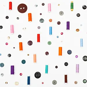 Reel Prints: many spools of sewing thread and various buttons