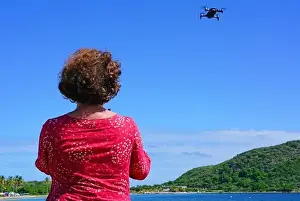 ST KITTS, ST KITTS AND NEVIS -21 NOV 2018- A woman taking pictures with a drone camera over the Caribbean Sea in