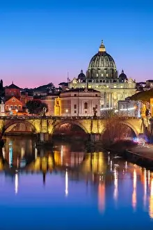 St. Peter's Basilica in Vatican City with the Tiber River passing through Rome, Italy at dusk