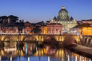St. Peter's Basilica in Vatican City with the Tiber River passing through Rome, Italy at dusk