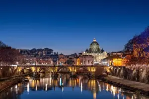 St. Peter's Basilica in Vatican City on the Tiber River through Rome, Italy at dusk