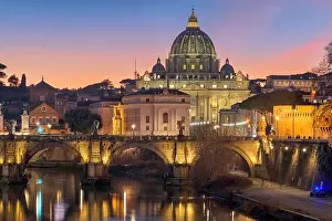 St. Peter's Basilica in Vatican City on the Tiber River through Rome, Italy at dusk