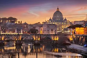 St. Peter's Basilica in Vatican City on the Tiber River through Rome, Italy at dusk