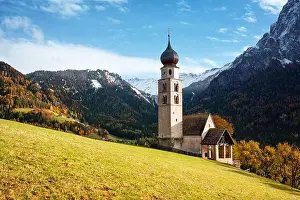 St. Valentin (Kastelruth) Village Church at the autumn Dolomite Alps. Amazing landscape with small chapel on sunny meadow