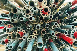 Galvanized Prints: Stack of used worn galvanized steel scaffold tubes and pipes on construction site