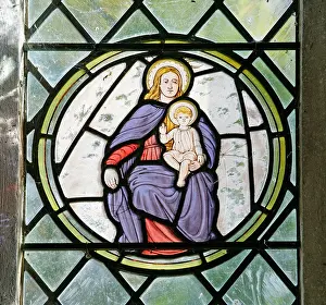 A stained glass window depicting Madonna and Child, All Saints Church, Thornage, Norfolk