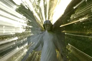 Assist Prints: standing angel sculpture surrounded by a dazzling aura of light