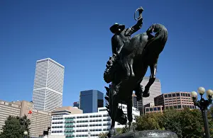 Denver Prints: Statue of cowboy on horse and Denver skyline Colorado October 2007