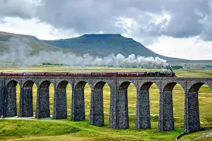 Class Prints: Steam train crossing the Ribblehead Viaduct on the Settle-Carlisle railway line with Ingleborough behind