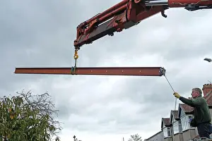 Beam Prints: A steel beam being lifted for a loft extension on a house