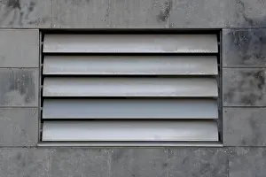 Ventilation Prints: Steel ventilation shutters on a concrete tile facade, metal louvers
