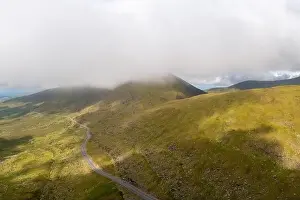 the steep and winding mountain road leading to the top of Connor Pass on the Dingle Peninsula