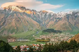 Stepantsminda Village At Sunny Evening Sunset In Kazbegi District, Mtskheta-Mtianeti Region, Georgia. Spring Summer Season Mountains Landscape