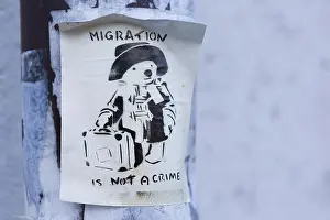 Refugees Prints: A sticker on a lampost in Germany showing Paddington Bear with text