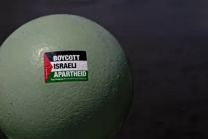 Gaza Prints: Sticker on a railing ball head over the River Thames reading 'Stop Israeli ApartHeid'