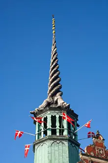 Danmark Prints: Former Stock Exchange Building with Danish flags flying from the dragon tail spire Copenhagen