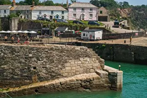 Boating Prints: Stone constructed harbour wall structure in foreground with coastal homes