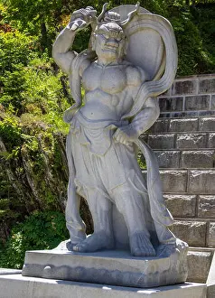 Praying Prints: Stone demon guard statuesque, guardian statue at the entrance to the Korean Buddhist Temple Guinsa