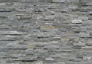 Cladding Prints: Stone wall cladding made of gray shades strips of rock. Background and texture