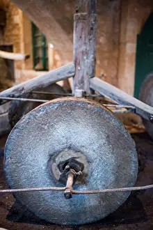 Grinder Prints: A stone wheel used in an olive press machine to produce olive oil