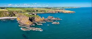 Stonehaven, United Kingdom - 23 June, 2022: panorama drone view of Dunnottar Castle and the wild coast of Aberdeenshire