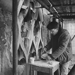 Restoring Prints: A stonemason working at Carlisle Cathedral applying SBD Certite during restoration on the tracery of a window
