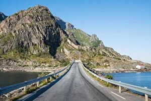 Images Dated 22nd July 2017: Straight asphalt road with mountain and sea against blue sky in Lofoten, Norway