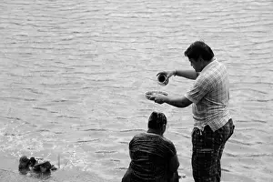 Pouring Prints: Strange Hindu ritual, Man pouring water on woman