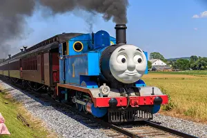 Bucolic Prints: Strasburg, PA, USA – June 19, 2016: Thomas the Tank Engine chugs toward the train station in Strasburg