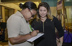 Stratford University Representative assisting an Educational Fair attendee
