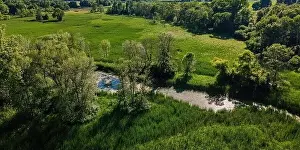 Midwest Usa Prints: A stream runs through the wilderness surrounded by natural woodland and meadows