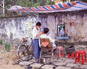 Saigon Prints: Street barber, Ho Chi Minh City (Saigon), Socialist Republic of Vietnam