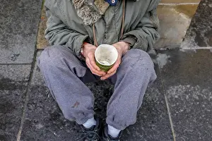 Homeless Prints: Street beggar, sitting on a pavement with a cardboard cup for collecting money and charity