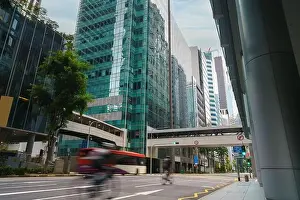 Street and car on traffic moving in downtown business financial district with skyscraper building in morning at Singapore