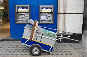 Dispenser Prints: Street cleaner trolley in front of Halifax cash dispensers