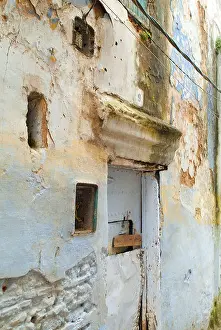 Decaying Prints: Street with decaying facade of a house Larache Morocco