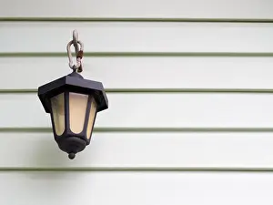 Opening Prints: Street lamp on a background of light green plastic battens