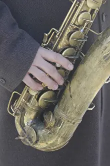 Saxophone Prints: Street musician playing the saxophone in a cold winter day New York United States Kike CAlvo V W instrument music sound