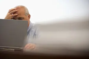 Rest Prints: Stressed business executive working on portable computer in office conference room