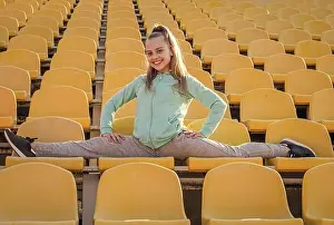 Flexibility Prints: Stretch and flex for your health. Flexible tween do splits on stadium seats. Leg stretch