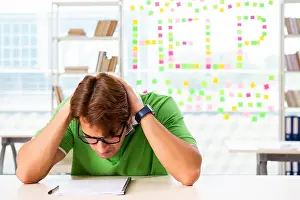 Concentrated Prints: Student struggling at the exam in classroom